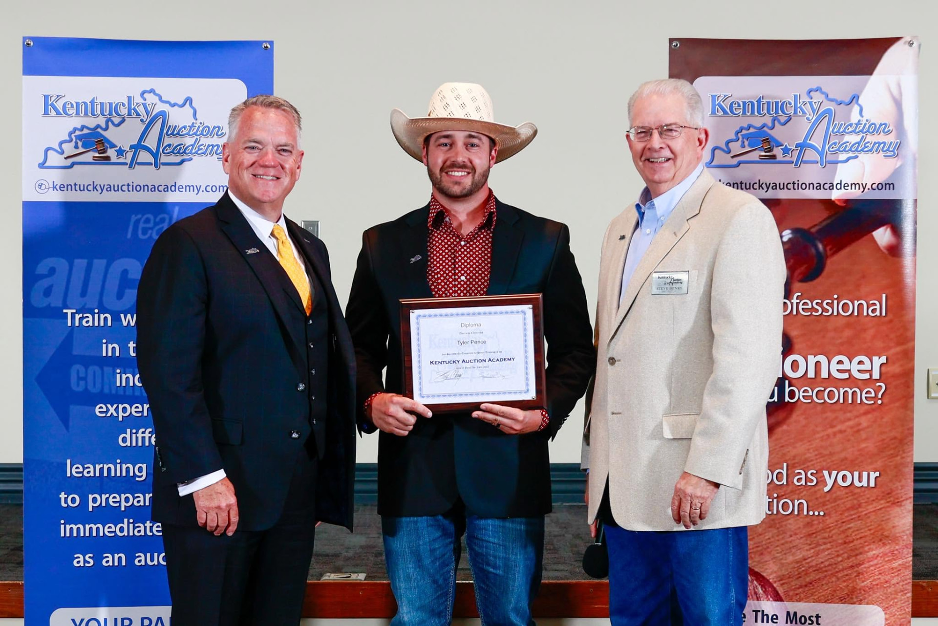 Tyler Pence receiving his Kentucky Auction Academy diploma